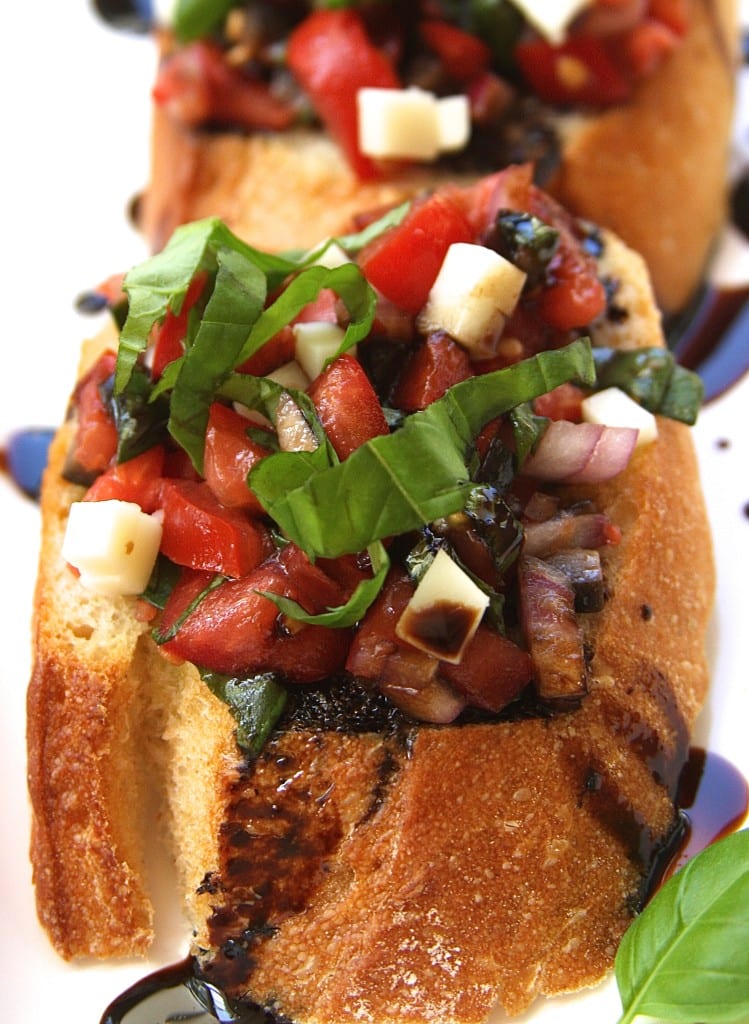 Imagine for a minute biting into the crispy bread. Hearing that perfect crackling noise as the tangy sweet balsamic reduction flows over your tongue AND ohhhh, the robust flavor of basil hits you. And ahhh, there it is, the sweetness of the tomato. Are you hungry yet for this Bruschetta with Balsamic Reduction?