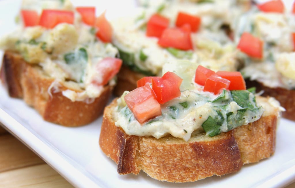 Veggie Dip on toast garnished with diced tomatoes