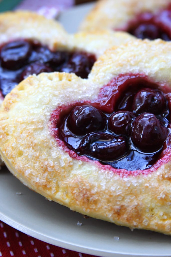 Cherry Heart Pies on a grey plate.