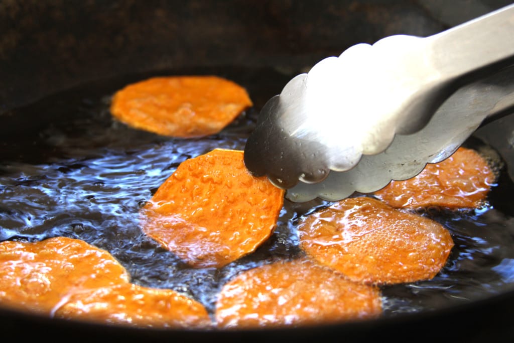 Turning the Homemade Sweet Potato Chips while frying.