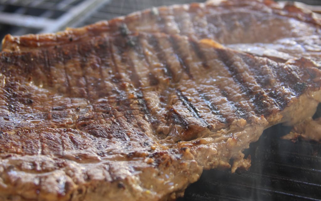 Grilling the grass-fed steak for Super Healthy Sweet Potato Nachos.
