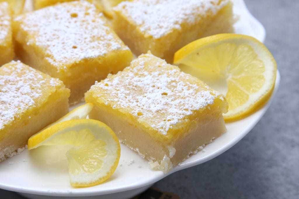 Lusciously Lemon Bars recipe is the perfect mouth watering treat for the lemon lovers in your life. Sweet, buttery and the companion with a cup of tea. These sunny little treats disappeared so fast.