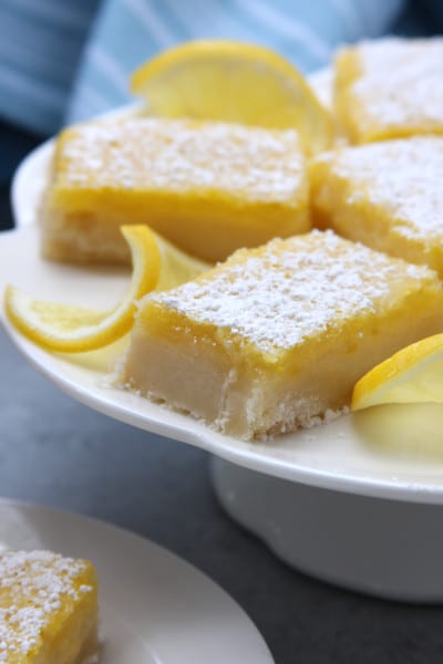 Lusciously Lemon Bars are rich, buttery and refreshing. Perfect lip-smacking treat for lemon lovers. These disappeared incredibly fast. Gluten free option included.