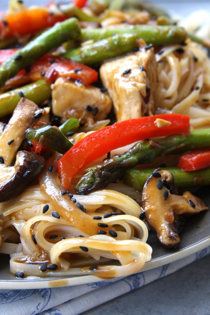 Lemongrass Chicken Noodle Stir Fry recipe Is healthy decadence on a plate. Packed with a ton of veggies and comforting rice noodles. It will make you want to curl of on the couch and indulge.