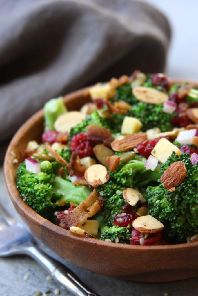 Super Healthy Broccoli Salad recipe is a twist on a classic with yogurt, pipits , chia and hemp seeds. Everyone gobbles this salad up and loves the crunch.