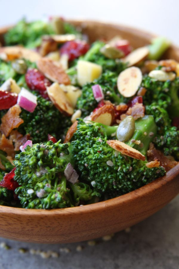 Super Healthy Broccoli Salad recipe is a twist on a classic with yogurt, pipits , chia and hemp seeds. Everyone gobbles this salad up and loves the crunch.