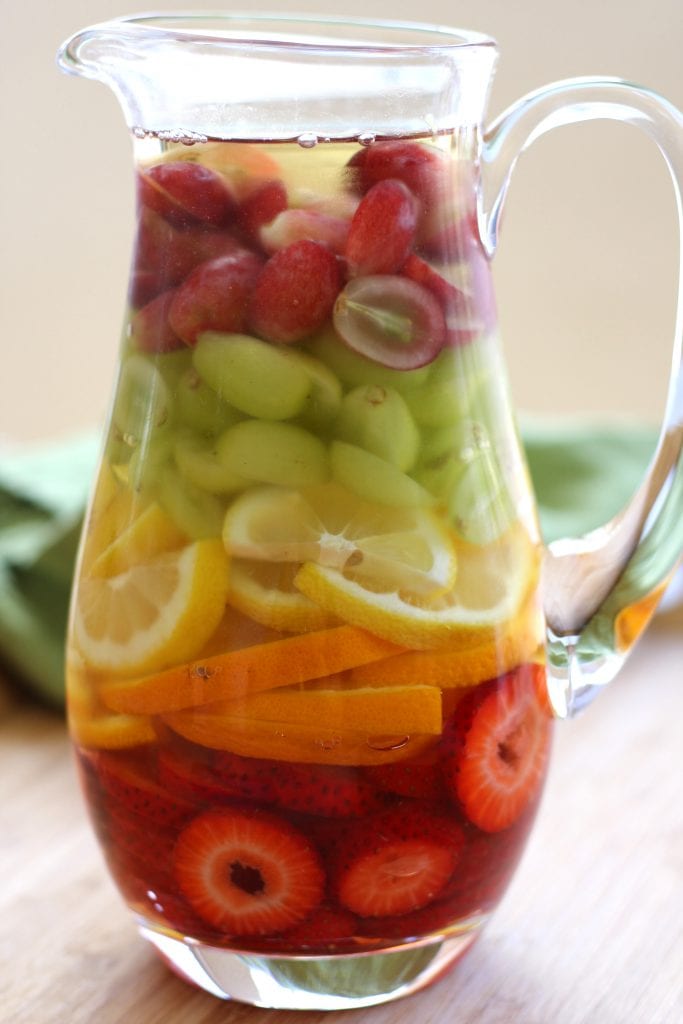 Rainbow Tequila Sangria recipe is a refreshing adult cocktail with strawberries, citrus and grapes all mingled with crisp sauvignon blanc and your favorite tequila. It is as much to look at as it is to drink.