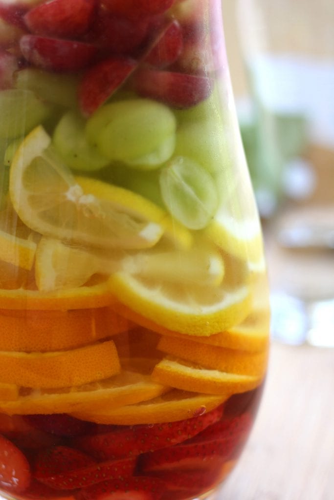 Rainbow Tequila Sangria recipe is a refreshing adult cocktail with strawberries, citrus and grapes all mingled with crisp sauvignon blanc and your favorite tequila. It is as much to look at as it is to drink.