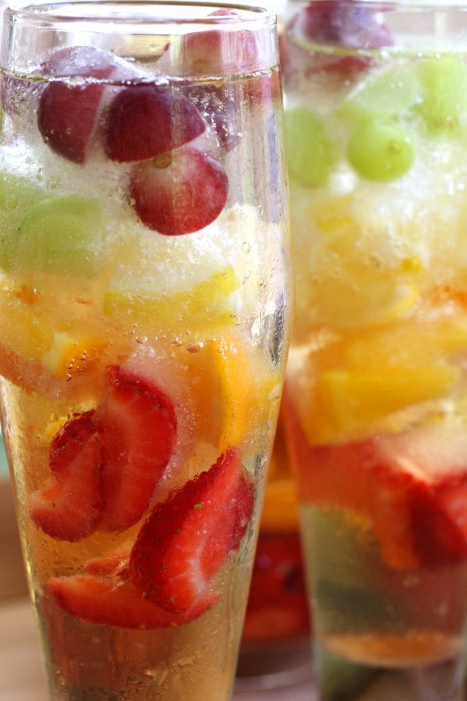 Rainbow Tequila Sangria recipe is a refreshing adult cocktail with strawberries, citrus and grapes all mingled with crisp sauvignon blanc and your favorite tequila. It is as much to look at as it is to drink.