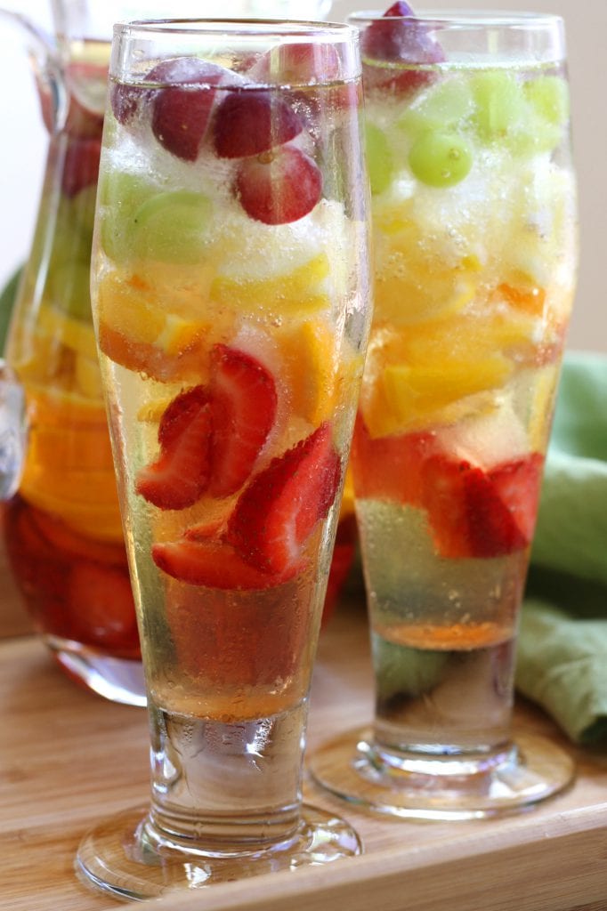 Rainbow Tequila Sangria recipe is a refreshing adult cocktail with strawberries, citrus and grapes all mingled with crisp sauvignon blanc and your favorite tequila. It is as much to look at as it is to drink.