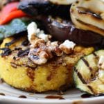 Rustic Italian Grilled Polenta & Vegetables recipe is a healthy & savory dish great for sharing. Polenta has flavors of rosemary and parmesan and is surrounded by grilled veggies and a balsamic reduction. Portable, tasty and vegetarian.