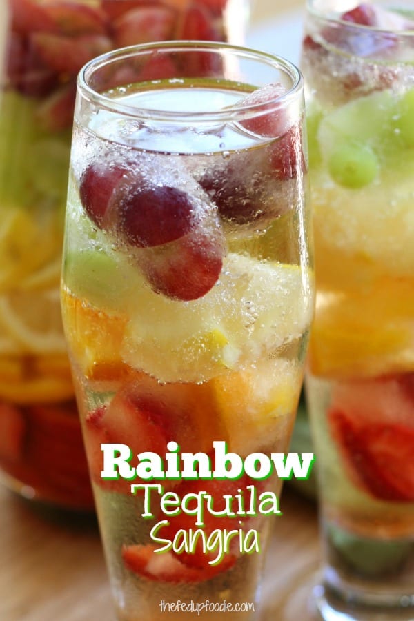 Rainbow Tequila Sangria recipe is a refreshing adult cocktail with strawberries, citrus and grapes all mingled with crisp sauvignon blanc and your favorite tequila. It is as much to look at as it is to drink. #thefedupfoodie #tequiladrinkrecipes #sangriatequila #sangriarecipes #sangria #mixeddrinks #sangriadrinks #sangriausingfrozenfruit https://www.thefedupfoodie.com