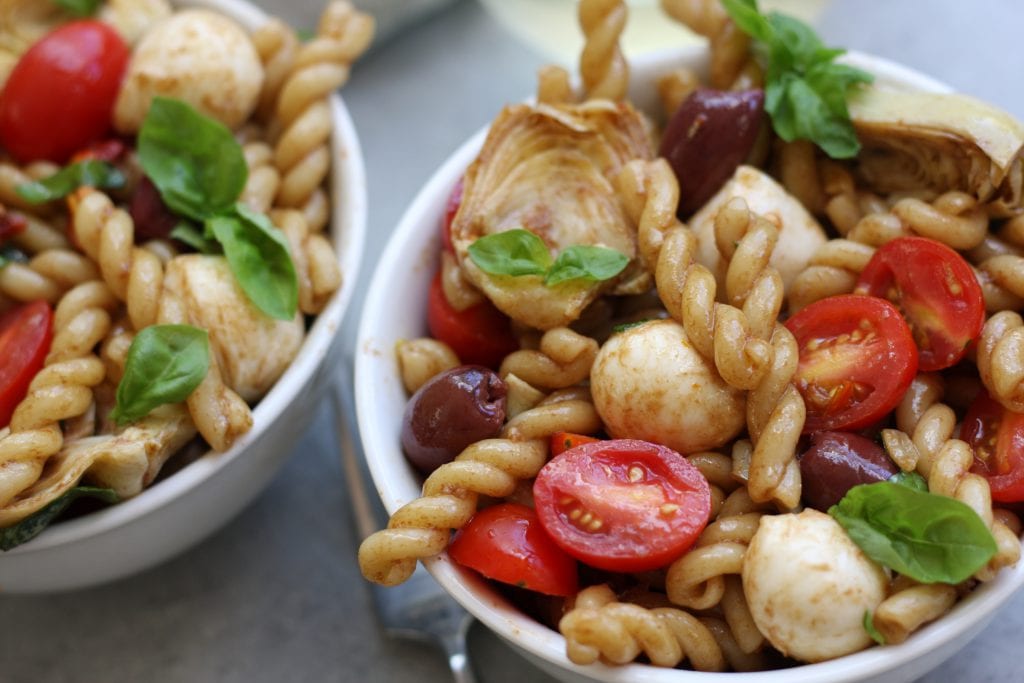 Mediterranean Delight Pasta Salad recipe is an absolute crowd pleaser with a balsamic vinaigrette, creamy mozzarella and artichoke hearts. Stopping at one bowl is impossible.