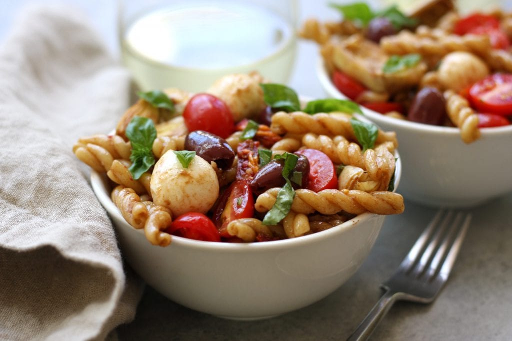 Mediterranean Delight Pasta Salad recipe is an absolute crowd pleaser with a balsamic vinaigrette, creamy mozzarella and artichoke hearts. Stopping at one bowl is impossible.