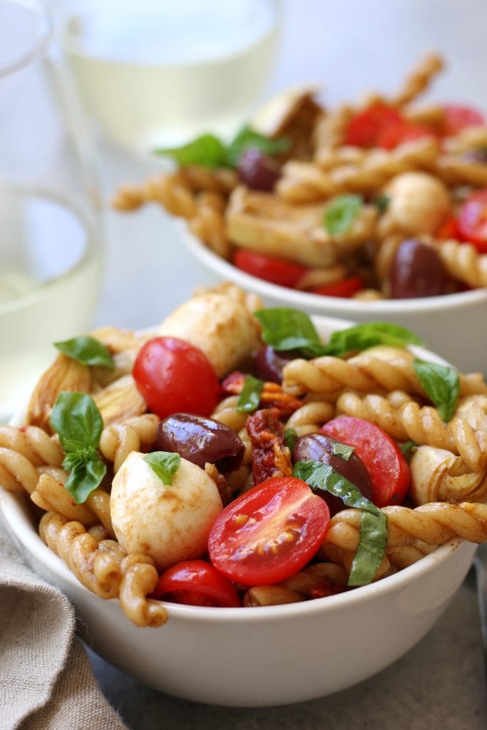 Mediterranean Delight Pasta Salad recipe is an absolute crowd pleaser with a balsamic vinaigrette, creamy mozzarella and artichoke hearts. Stopping at one bowl is impossible.