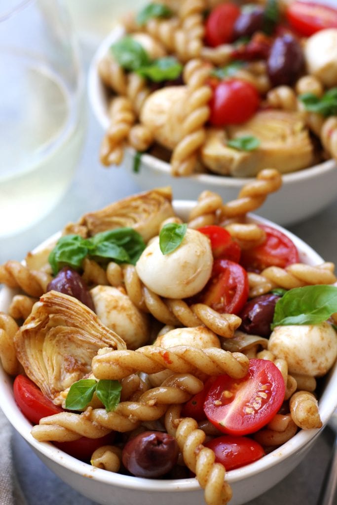 Mediterranean Delight Pasta Salad recipe is an absolute crowd pleaser with a balsamic vinaigrette, creamy mozzarella and artichoke hearts. Stopping at one bowl is impossible.