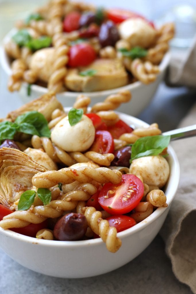Mediterranean Delight Pasta Salad recipe is an absolute crowd pleaser with a balsamic vinaigrette, creamy mozzarella and artichoke hearts. Stopping at one bowl is impossible.