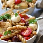 Mediterranean Delight Pasta Salad recipe is an absolute crowd pleaser with a balsamic vinaigrette, creamy mozzarella and artichoke hearts. Stopping at one bowl is impossible.