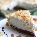 A cherished Hawaiian dessert,Haupia Pie with Macadamia Crust is as exciting to eat as attending your first luau. This gorgeous pie has a flaky and nutty crust, rich coconut chocolate layer, coconut cream layer all topped with fluffy whipped cream. You will be in heaven from the first bite.