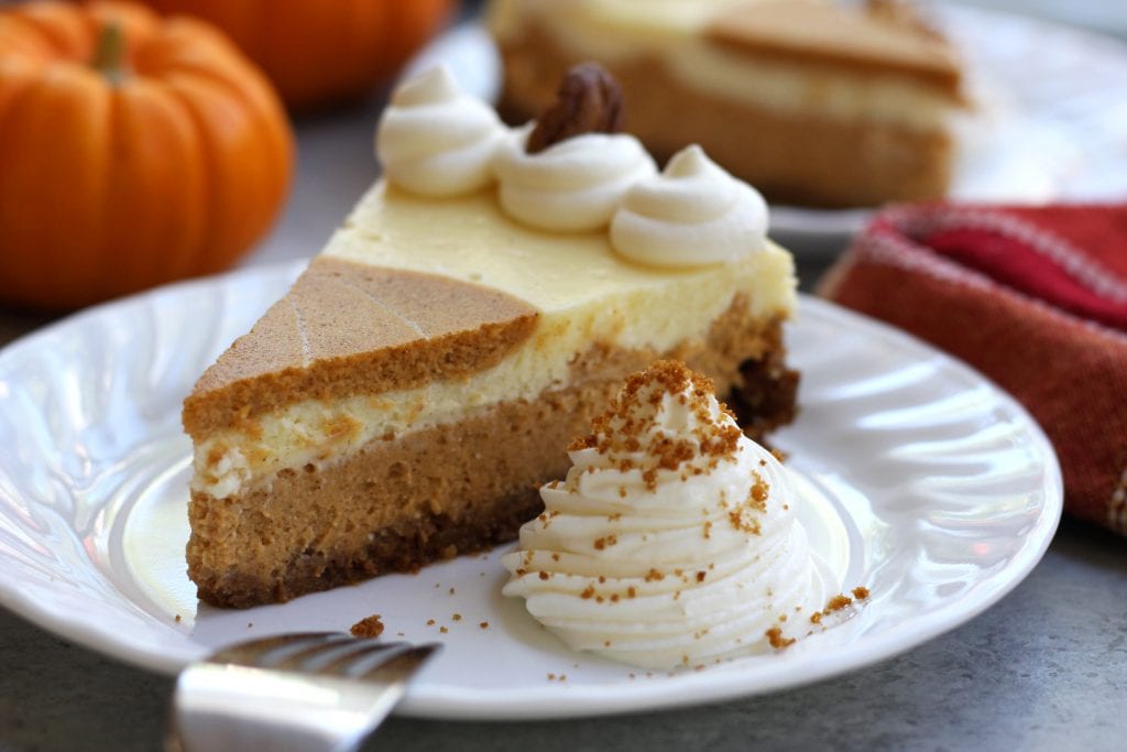 Creamy and decadent, this Pumpkin Cheesecake stands above the rest with a gingersnap, graham and pecan crust. Layered pumpkin and vanilla cheesecake makes this a beautiful and delicious dessert for your Holidays.