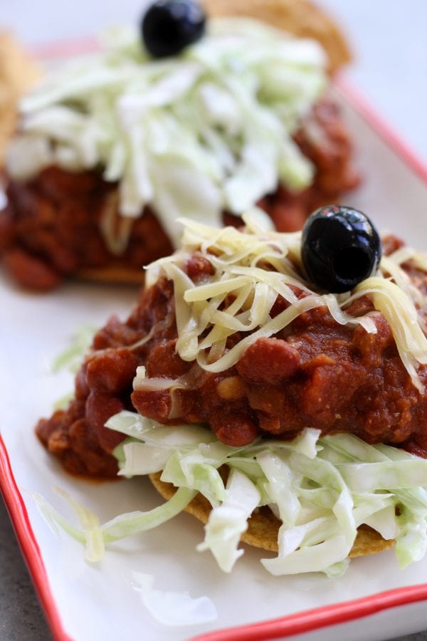 Tortilla and Beans is a family recipe dating back over 70 years. A crispy corn tortilla is topped with a hearty chili, simple coleslaw and black olives. Delicious, satisfying and budget friendly, this is a meal my husband can't get enough of.