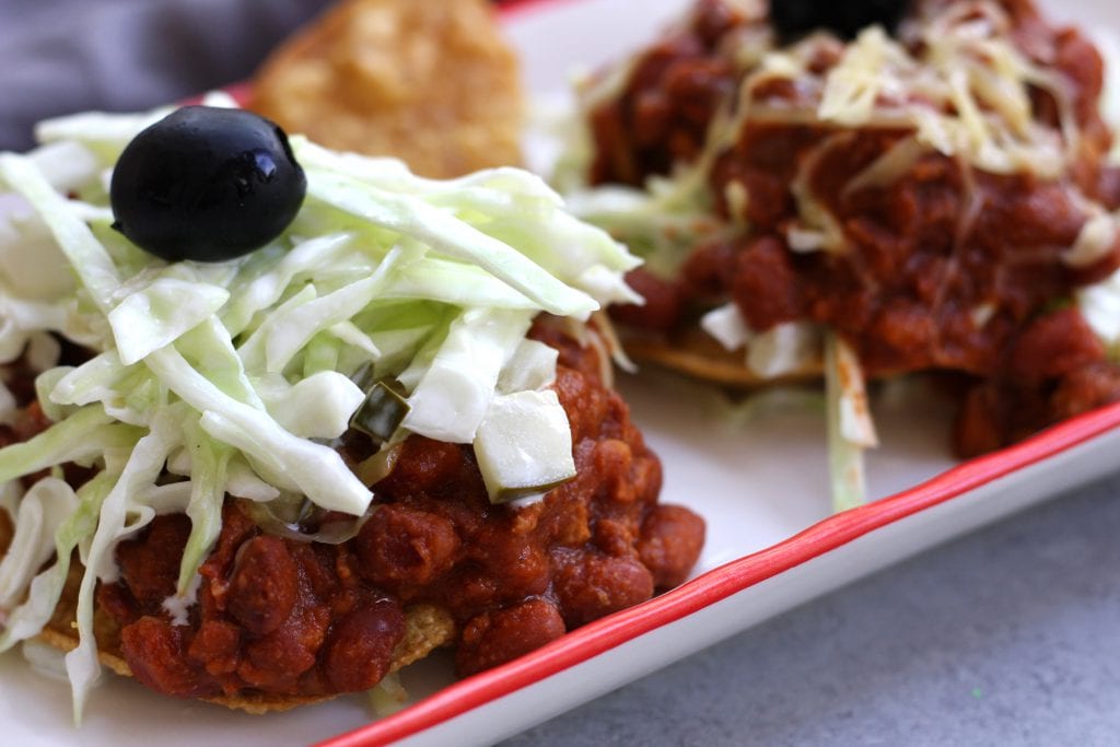 Tortilla and Beans is a family recipe dating back over 70 years. A crispy corn tortilla is topped with a hearty chili, simple coleslaw and black olives. Delicious, satisfying and budget friendly, this is a meal my husband can't get enough of.