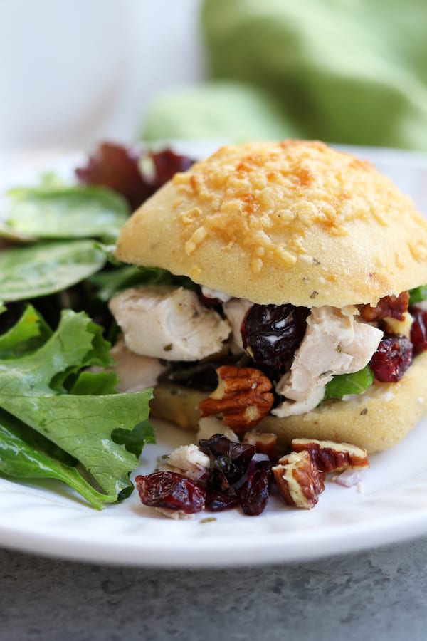 Pecan Cranberry Chicken Salad makes a perfect light and tasty lunch nestled in your favorite bread. Sweet, creamy and savory, you will feel like you just had lunch at a sidewalk cafe.