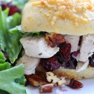 Pecan Cranberry Chicken Salad makes a perfect light and tasty lunch nestled in your favorite bread. Sweet, creamy and savory, you will feel like you just had lunch at a sidewalk cafe.