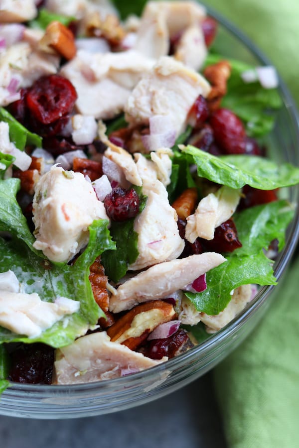 Pecan Cranberry Chicken Salad makes a perfect light and tasty lunch nestled in your favorite bread. Sweet, creamy and savory, you will feel like you just had lunch at a sidewalk cafe.