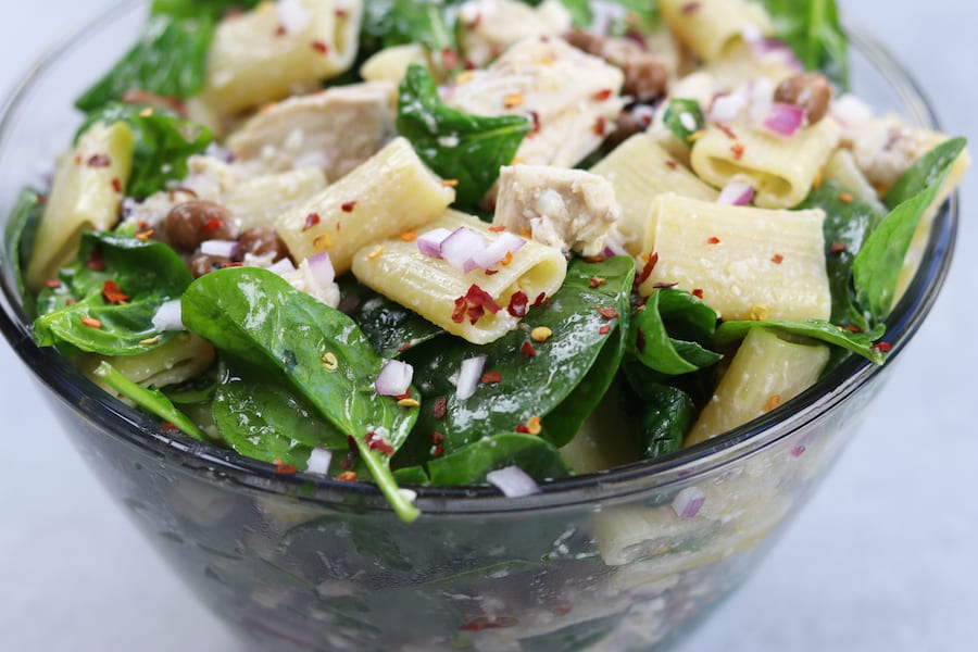 Zesty Chicken Pasta Salad has a subtle balance of tang to spice with red chili pepper flakes, feta, onion and garlic. Simple, fresh and easy to make, this pasta salad is perfect anytime of year.