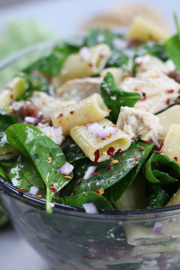 Zesty Chicken Pasta Salad has a subtle balance of tang to spice with red chili pepper flakes, feta, onion and garlic. Simple, fresh and easy to make, this pasta salad is perfect anytime of year.