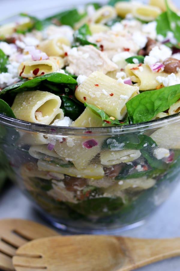 Zesty Chicken Pasta Salad has a subtle balance of tang to spice with red chili pepper flakes, feta, onion and garlic. Simple, fresh and easy to make, this pasta salad is perfect anytime of year.