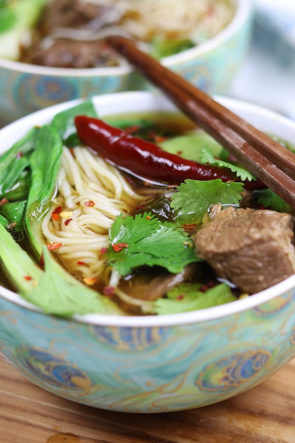 Beef Asian Noodle Soup is love at first bite or should I say Slurp? Tender beef and crispy baby bok choy is served over a rich Asian spiced broth with gratifying lacy noodles.