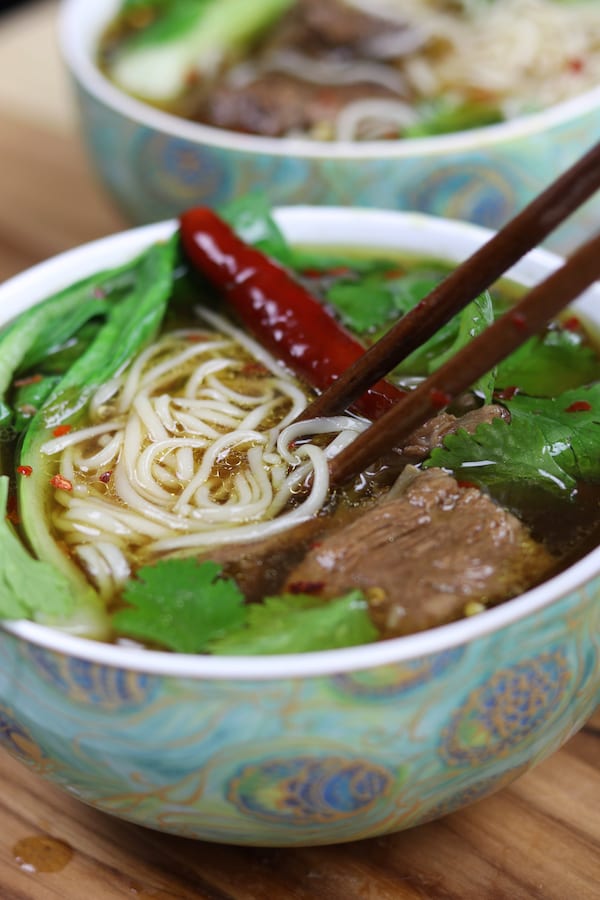 Beef Asian Noodle Soup is love at first bite or should I say Slurp? Tender beef and crispy baby bok choy is served over a rich Asian spiced broth with gratifying lacy noodles.