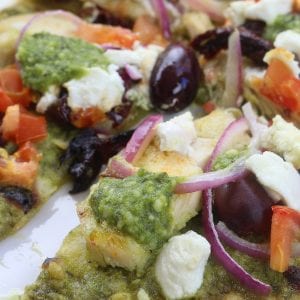 Easy and delicious, Chicken Pesto Naan Pizza comes together in minutes with kalamata olives, goat cheese and red onions. Perfect for busy weeknights without composing flavor.