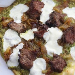Caramelized Onion Steak Naan Pesto Pizza has the perfect marriage of sweet buttery caramelized onions, herby pesto and satisfying steak. Ingredients can be made ahead of time for a delicious dinner that comes together in a little over 10 minutes.
