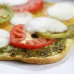 Light and summery, Heirloom Tomato Pesto Naan Pizza is a quick and easy recipe perfect for curing the take out cravings.