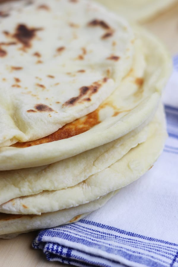 Learn the basics of making Homemade Naan, an easy & fluffy skillet bread that goes perfectly with Indian dishes or can be used to make pizza. 