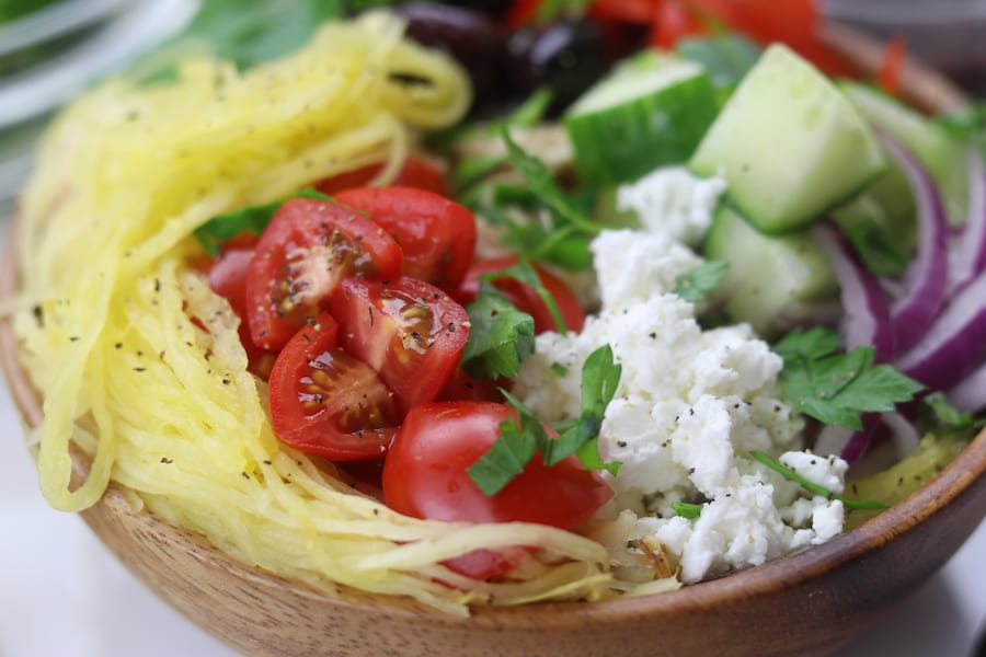 Spaghetti Squash Greek Bowls are an easy low-carb meal perfect for summer. Mix and match your favorite Greek toppings and drizzle on the popular dressing. You will love these!