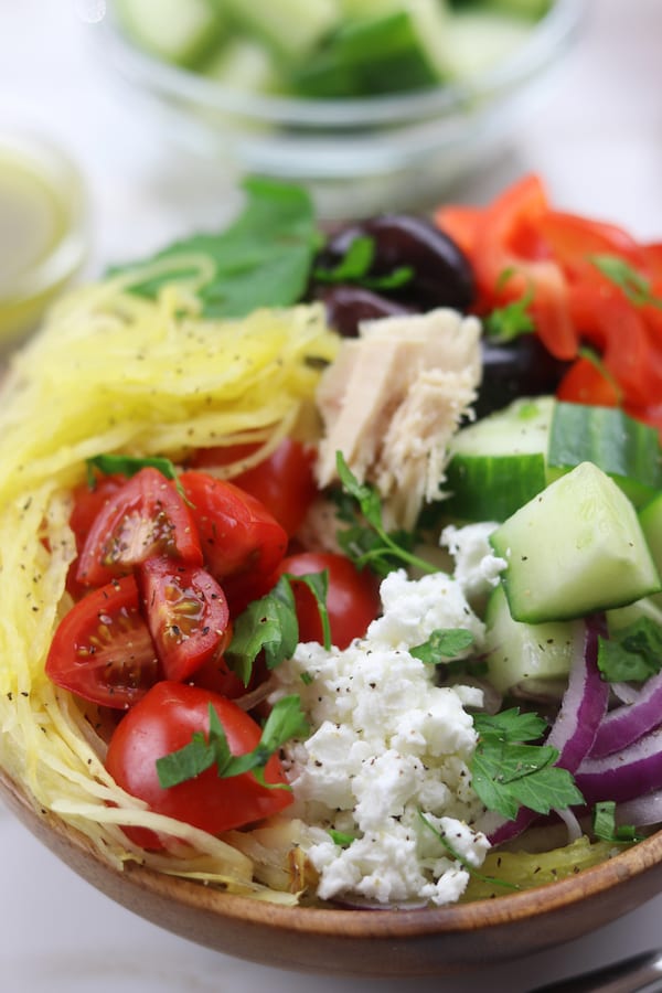 Spaghetti Squash Greek Bowls are an easy low-carb meal perfect for summer. Mix and match your favorite Greek toppings and drizzle on the popular dressing. You will love these!