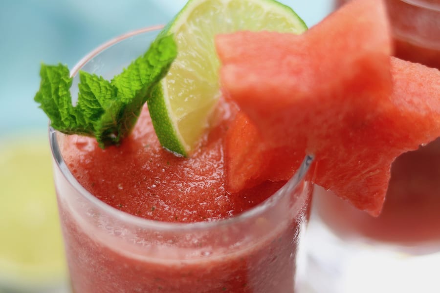 Frozen Watermelon Mojitos is the drink of summer! An adult-beverage speckled with mint, a hint of lime, watermelon simple syrup and incredibly refreshing icy watermelon. It is dangerously delicious!