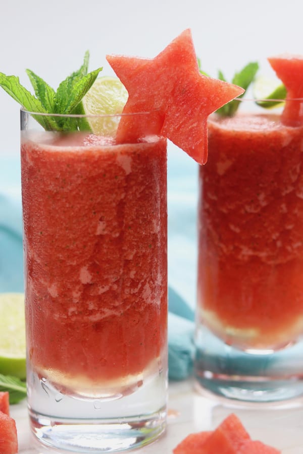 Frozen Watermelon Mojitos is the drink of summer! An adult-beverage speckled with mint, a hint of lime, watermelon simple syrup and incredibly refreshing icy watermelon. It is dangerously delicious!