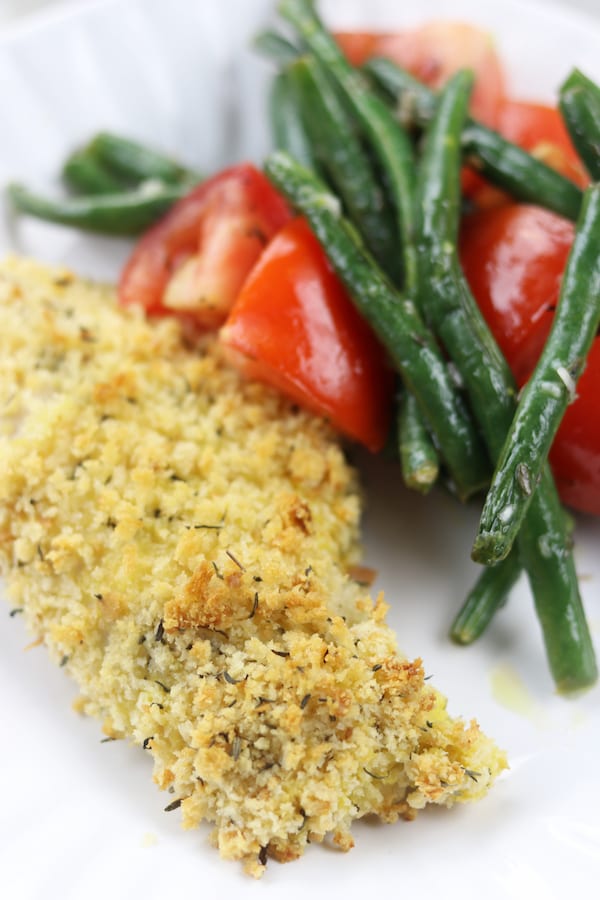 A sheet pan dinner with herby panko chicken and baked green beans that are easily dressed into a salad. Light and healthy, this is a perfect week night dinner.