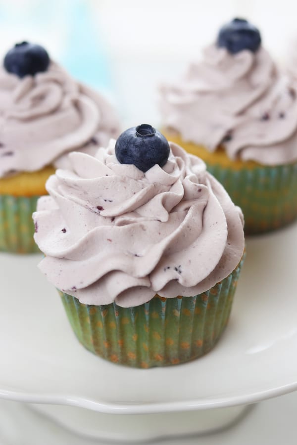 Vanilla Bean Blueberry Cream Cupcakes recipe creates moist and tender homemade cupcakes with a fluffy blueberry whipped cream frosting. These heavenly cupcakes are easy enough to make for an everyday treat but delicious enough for special occasions.