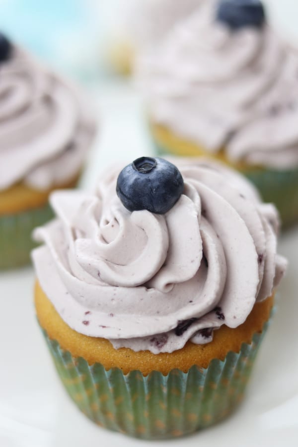 Vanilla Bean Blueberry Cream Cupcakes recipe creates moist and tender homemade cupcakes with a fluffy blueberry whipped cream frosting. These heavenly cupcakes are easy enough to make for an everyday treat but delicious enough for special occasions.