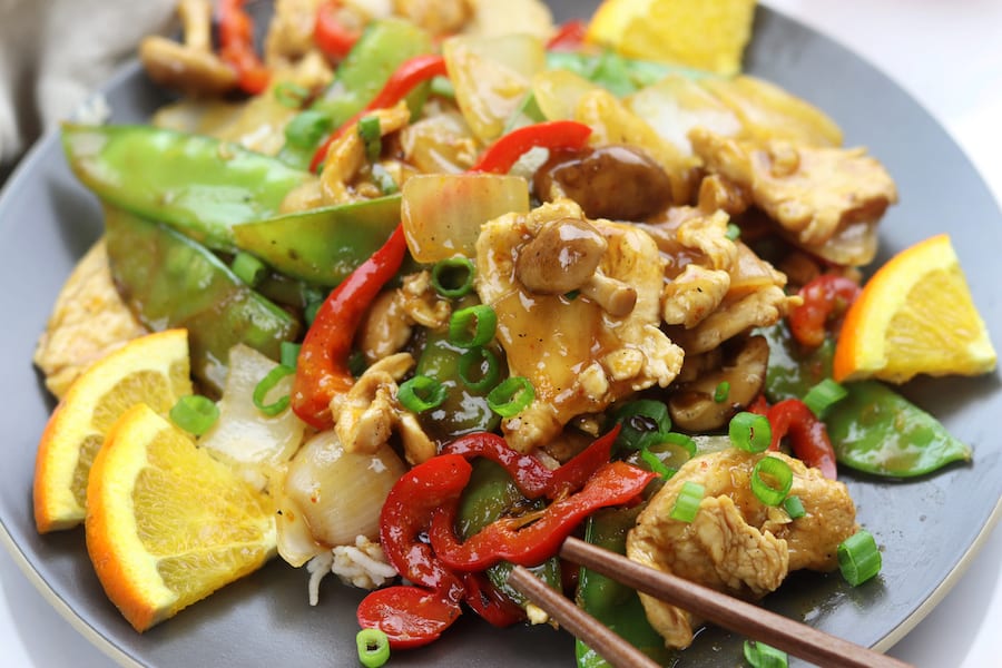Citrus Chicken Stir Fry recipe is clean eating at its best. Stir fried veggies and chicken are covered in a savory soy orange sauce. A family favorite recipe that comes together in less than 30 minutes.