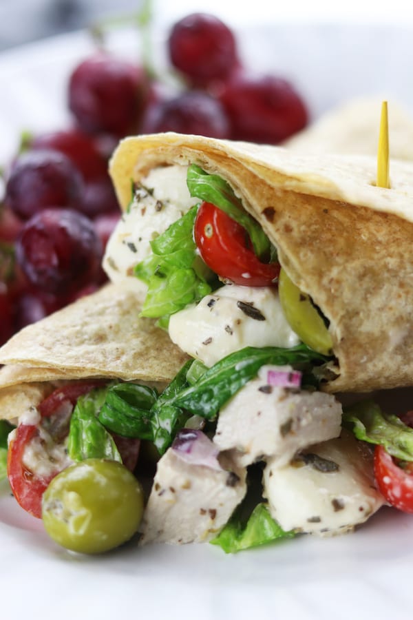 Creamy Italian Chicken Salad Wrap recipe is an easy and delicious meal. A whole wheat tortilla holds baked chicken, mozzarella cheese, veggies and a homemade creamy Italian dressing. Always a favorite as a make ahead lunch!
