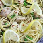 Skinny Lemon Chicken Pasta recipe is delicious enough for company and yet easy enough for a weeknight lighter meal. Tender chicken, artichoke hearts and peas are covered in a lemony garlic sauce. Serve with your favorite pasta, it is a favorite healthy decadent feast!