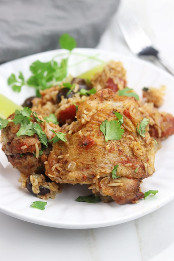 One Pot Spanish Chicken and Rice recipe is a simple, comforting meal bursting with flavor. An easy 15 minutes to prep and then pop in the oven to bake, this has become one of my favorite go to recipes that even children love. 