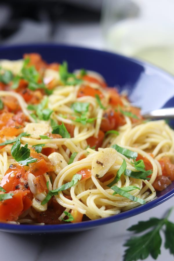 Simple Angel Hair Pasta recipe has only 5 ingredients but feels like an Italian feast. Add your favorite protein or leave as is for a favorite vegetarian meal. Perfect for a quick and easy dinner.